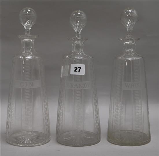 Three cut glass named spirit decanters, Brandy, Whisky and Gin height 30cm